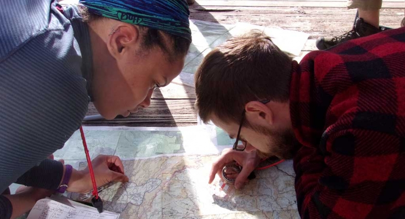 Two people examine a map